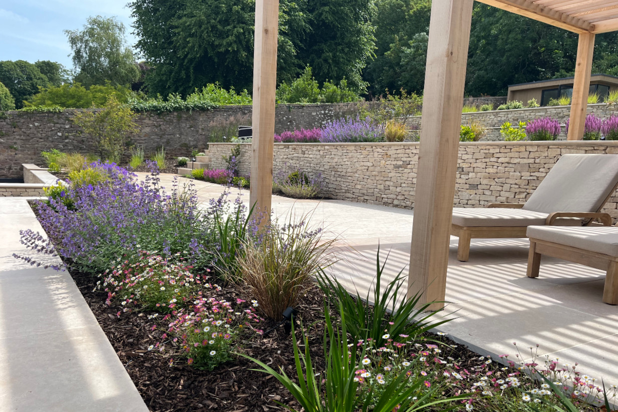 contemporary-garden-stoke-bishop-1 sun loungers beneath a pergola