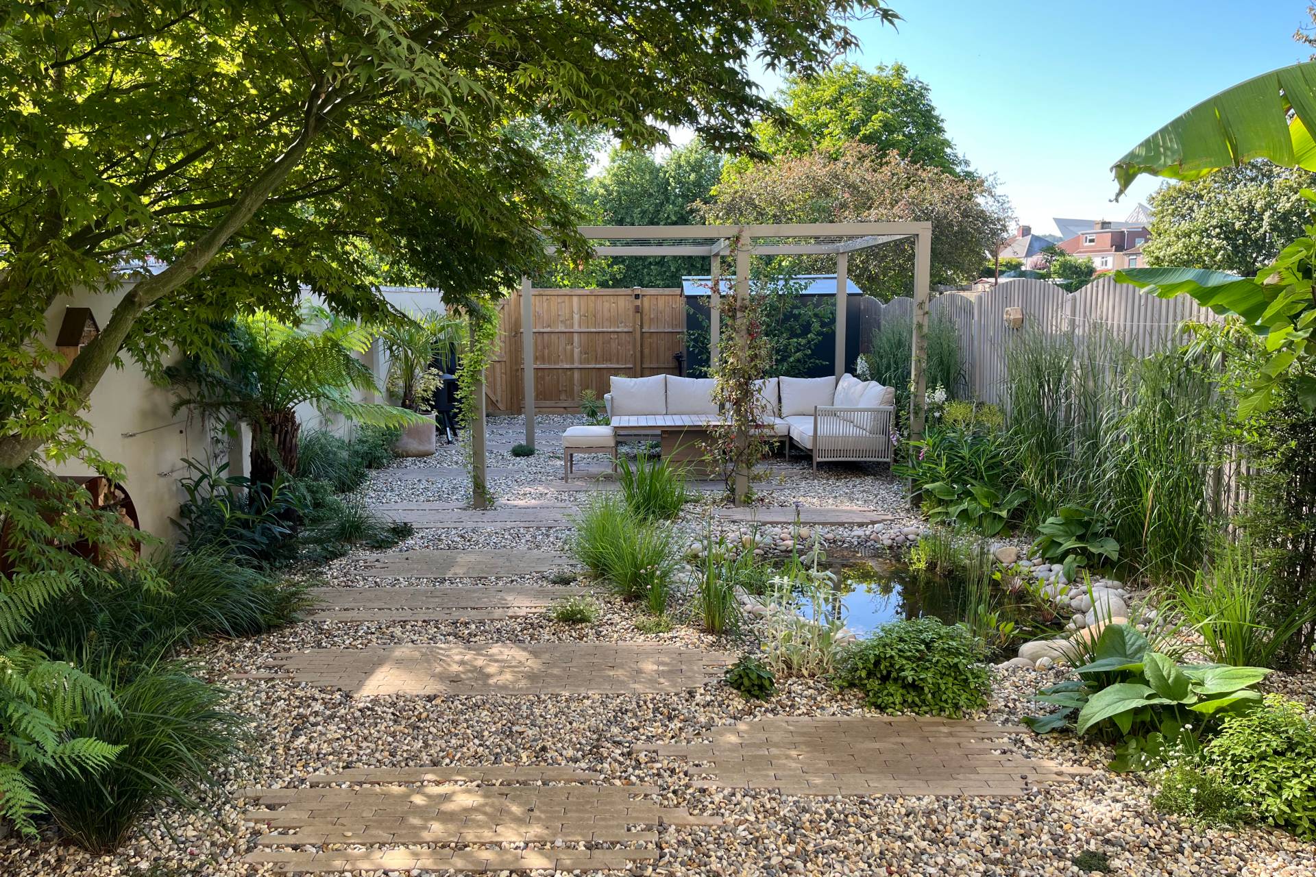Hillside garden with oak pergola and dining table