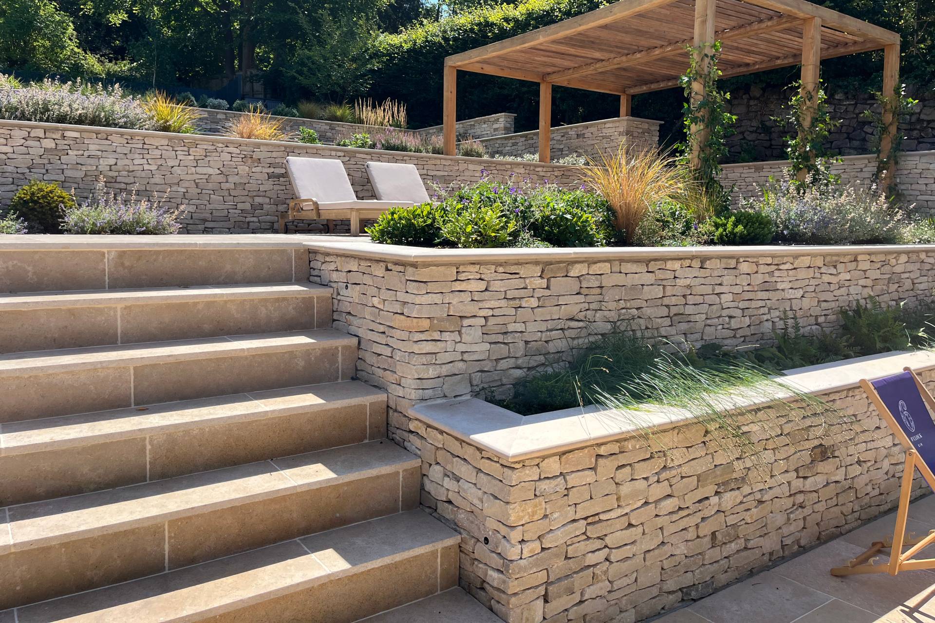 Bristol contemporary garden with view through ornamental grass to garden seating area 