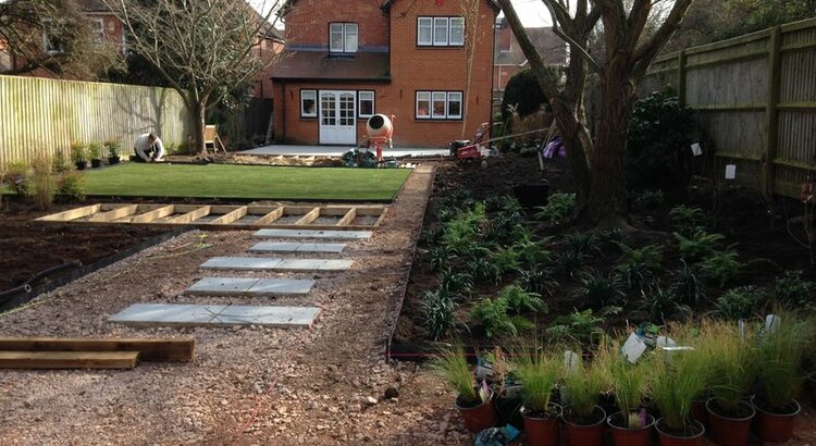 Garden during landscaping with woodland planting, decking and lawn