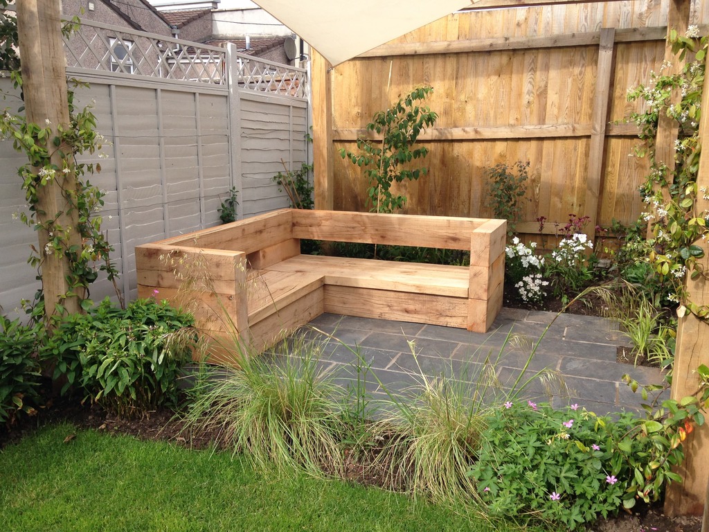 oak outdoor bench in seating area of plant lover's garden in Bristol