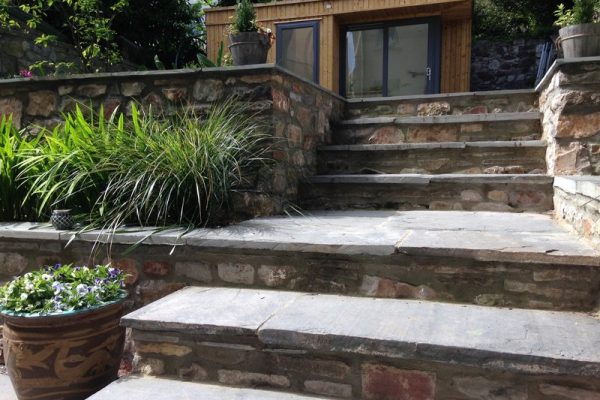 Terraced garden with slate steps and raised beds